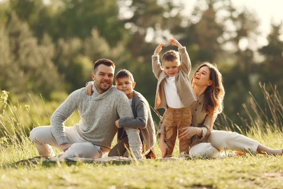 Family sitting together outdoors, representing family formation, surrogacy, and parentage legal support.
